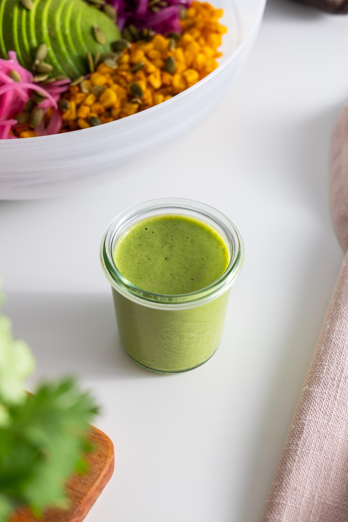 Creamy cilantro dressing in a small glass jar.