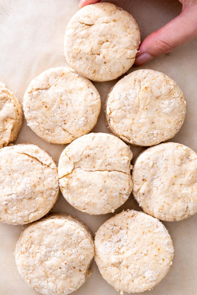 Close-up of uncooked vegan scone dough on parchment paper.