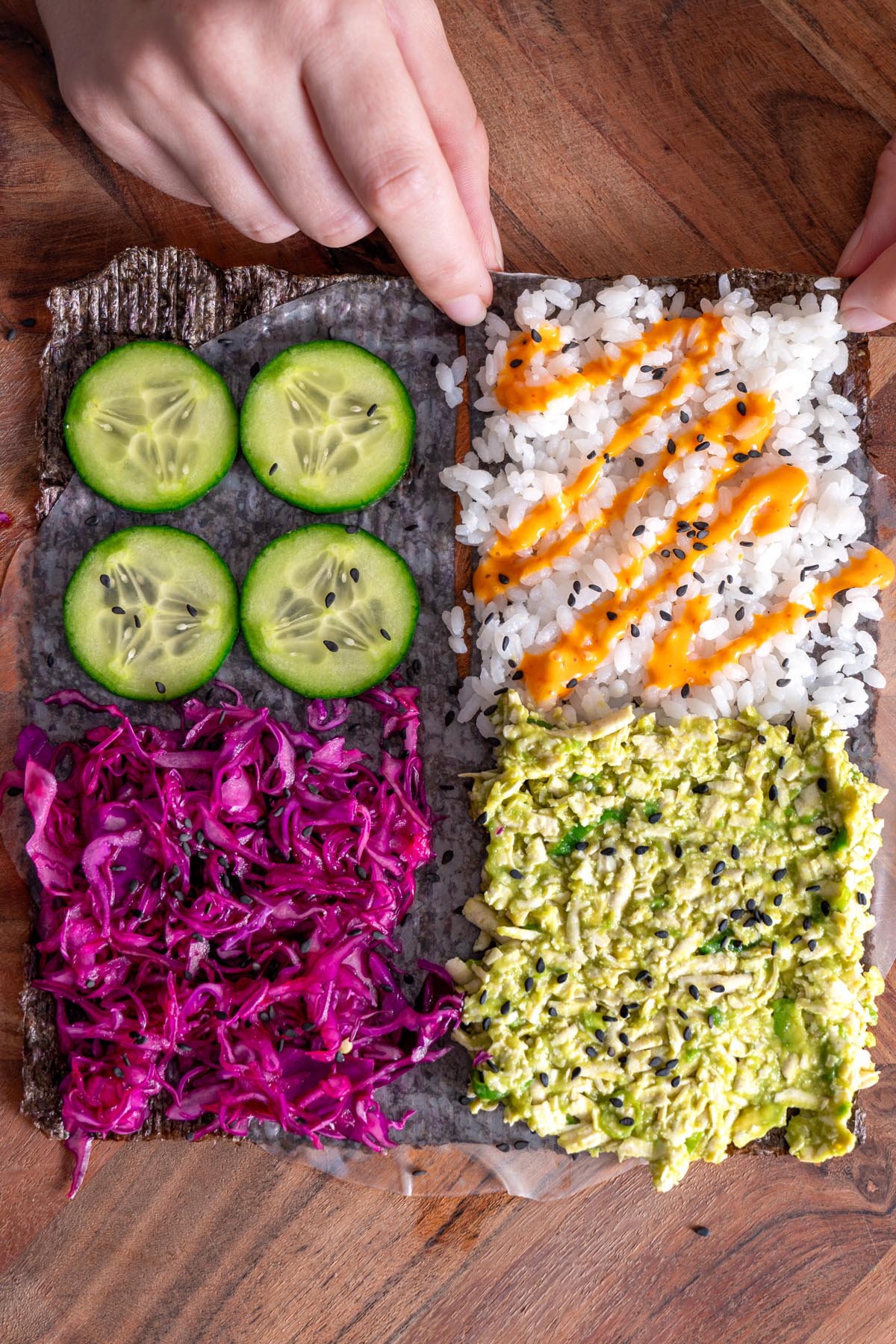 Overview of ingredients arranged on a nori sheet for a vegan sushi wrap.