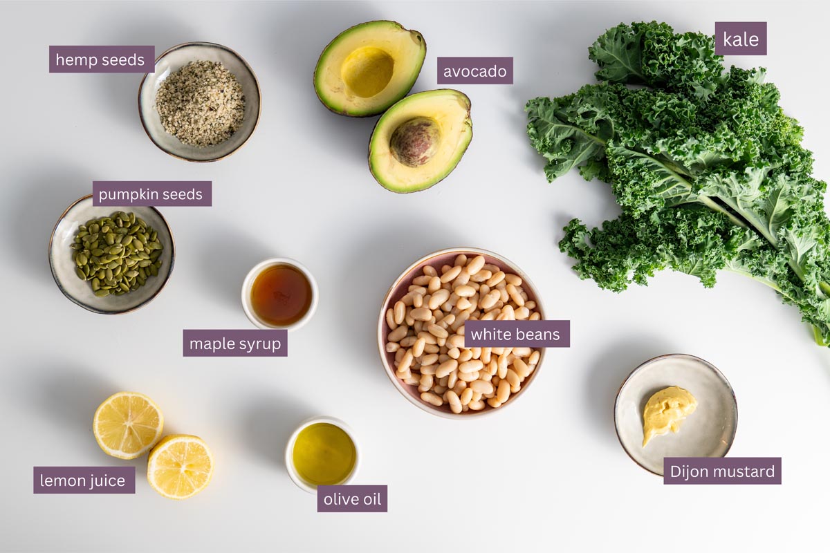 Vibrant ingredients for an Erewhon kale salad on a white surface