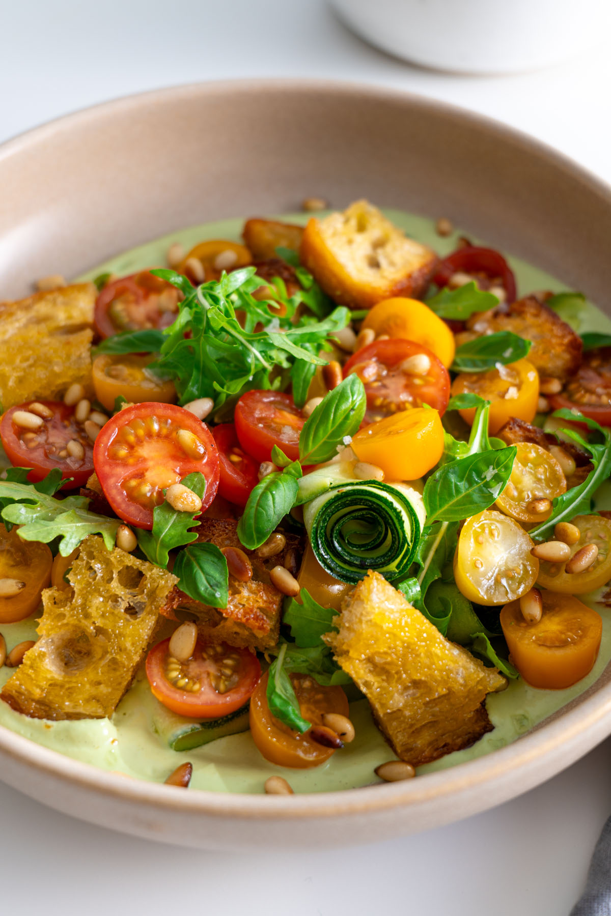 Close-up of the high-protein pesto bowl showcasing the vibrant ingredients and creamy basil sauce.