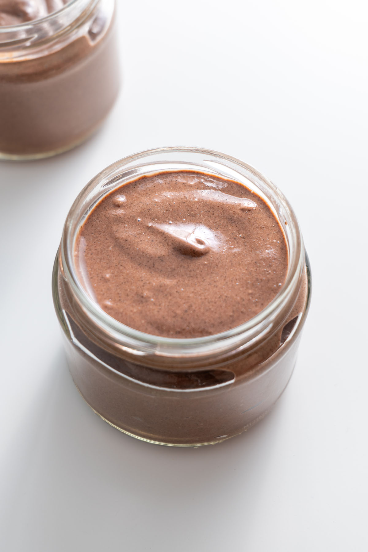 Smooth cacao chia pudding in a jar without toppings.
