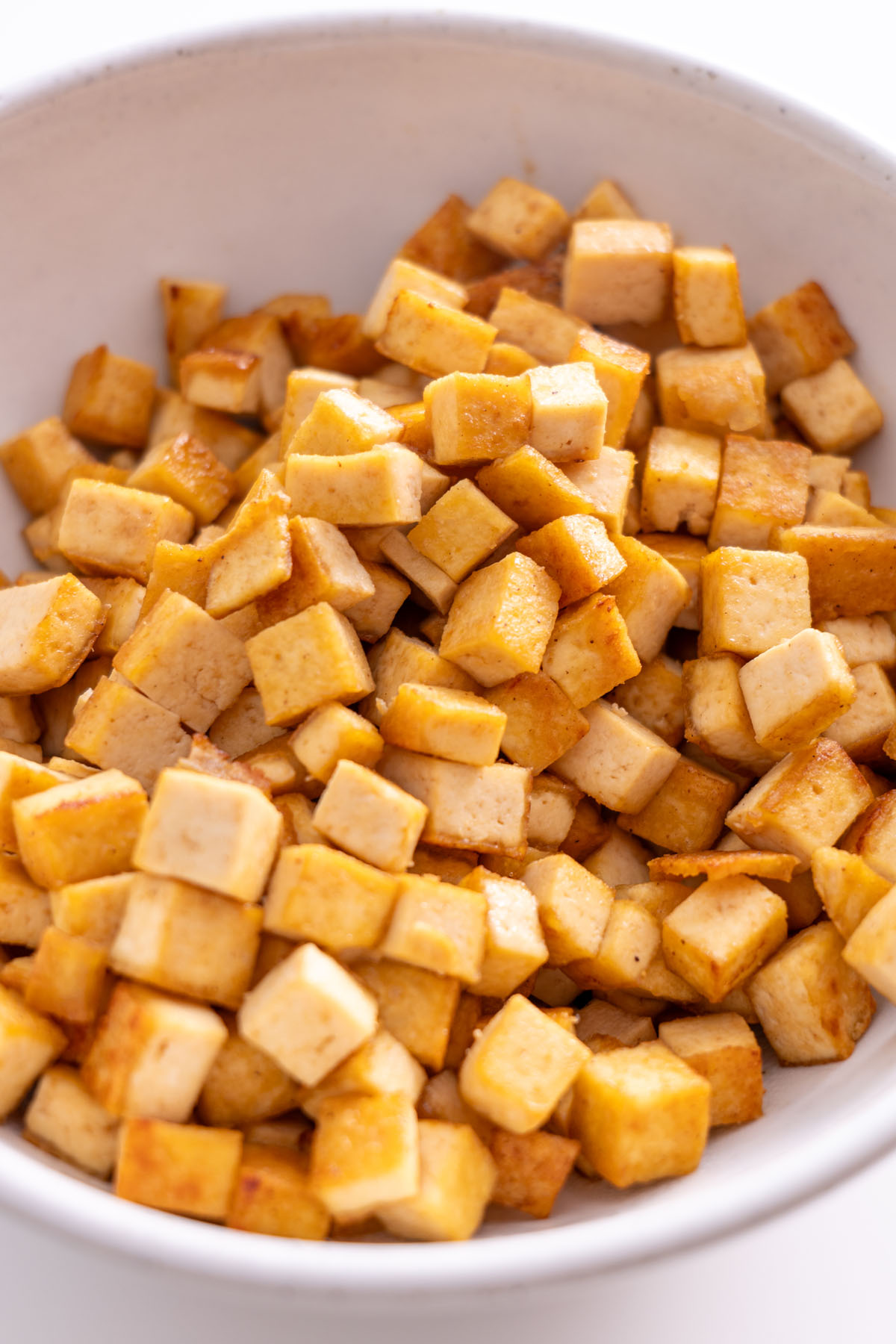 Crispy tofu cubes in a bowl, ready to be added to the sushi bowl.