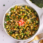 Overhead view of a High-Protein Vegan Sushi Bowl with nori sheets on the side.
