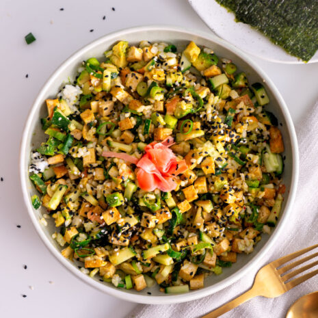 Overhead view of a High-Protein Vegan Sushi Bowl with nori sheets on the side.