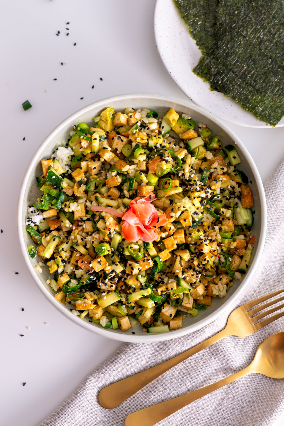 Overhead view of a High-Protein Vegan Sushi Bowl with nori sheets on the side.