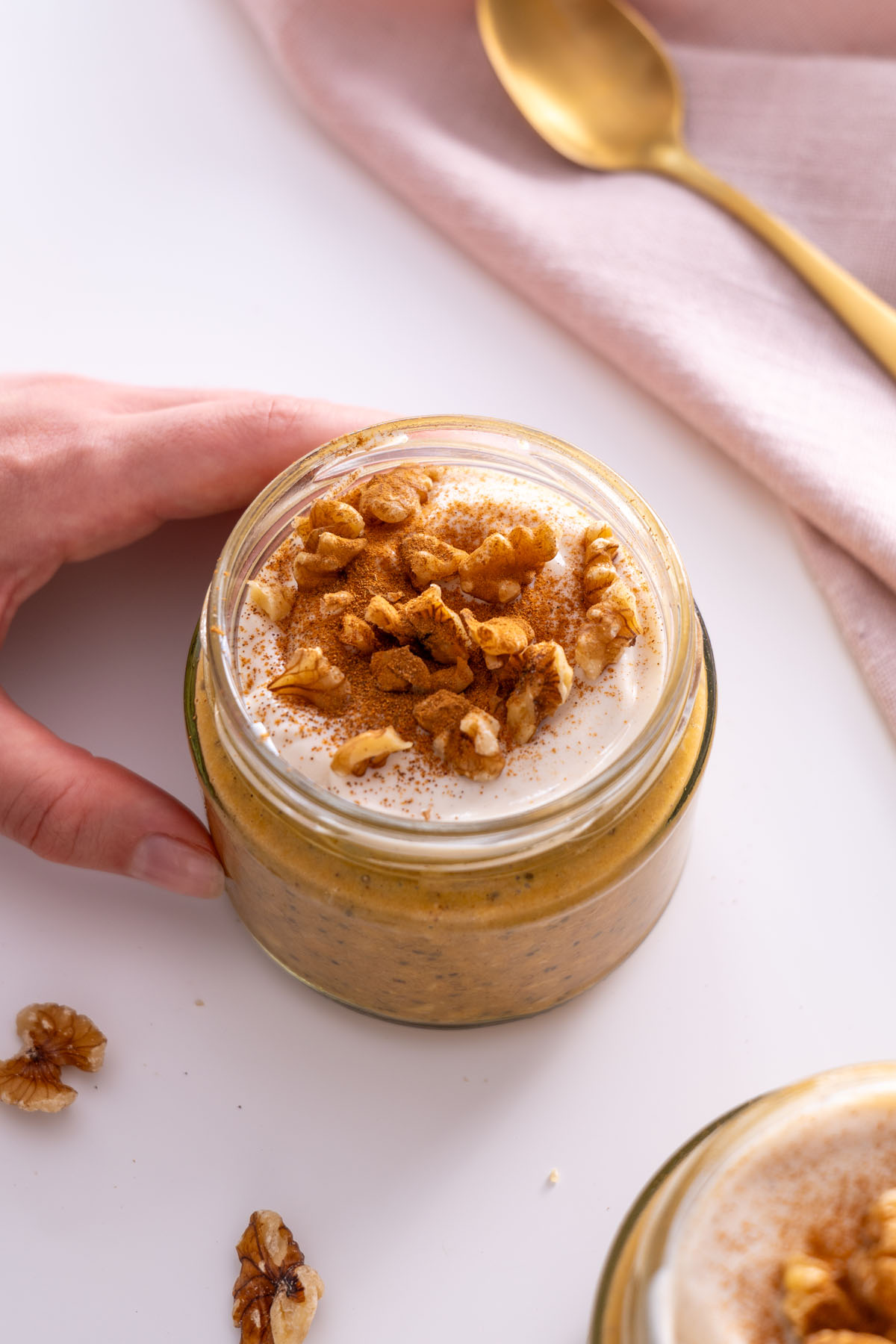 Close-up of pumpkin spice overnight oats topped with yogurt and walnuts