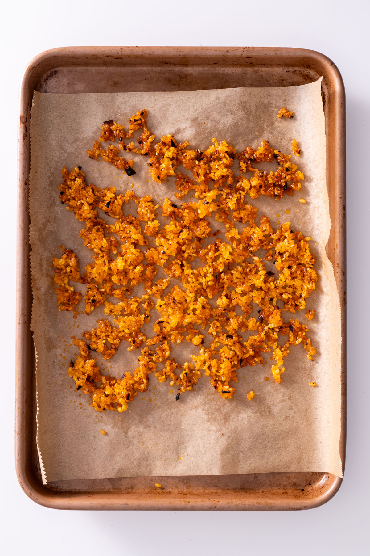 Crispy rice baked on parchment paper, golden and crunchy.