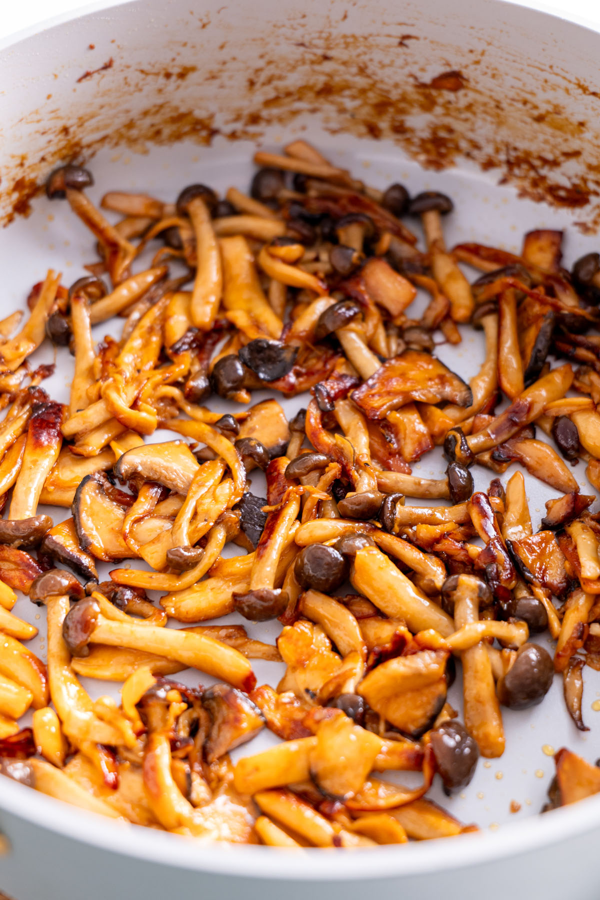 Sautéed gochujang mushrooms in a pan for crispy rice salad.