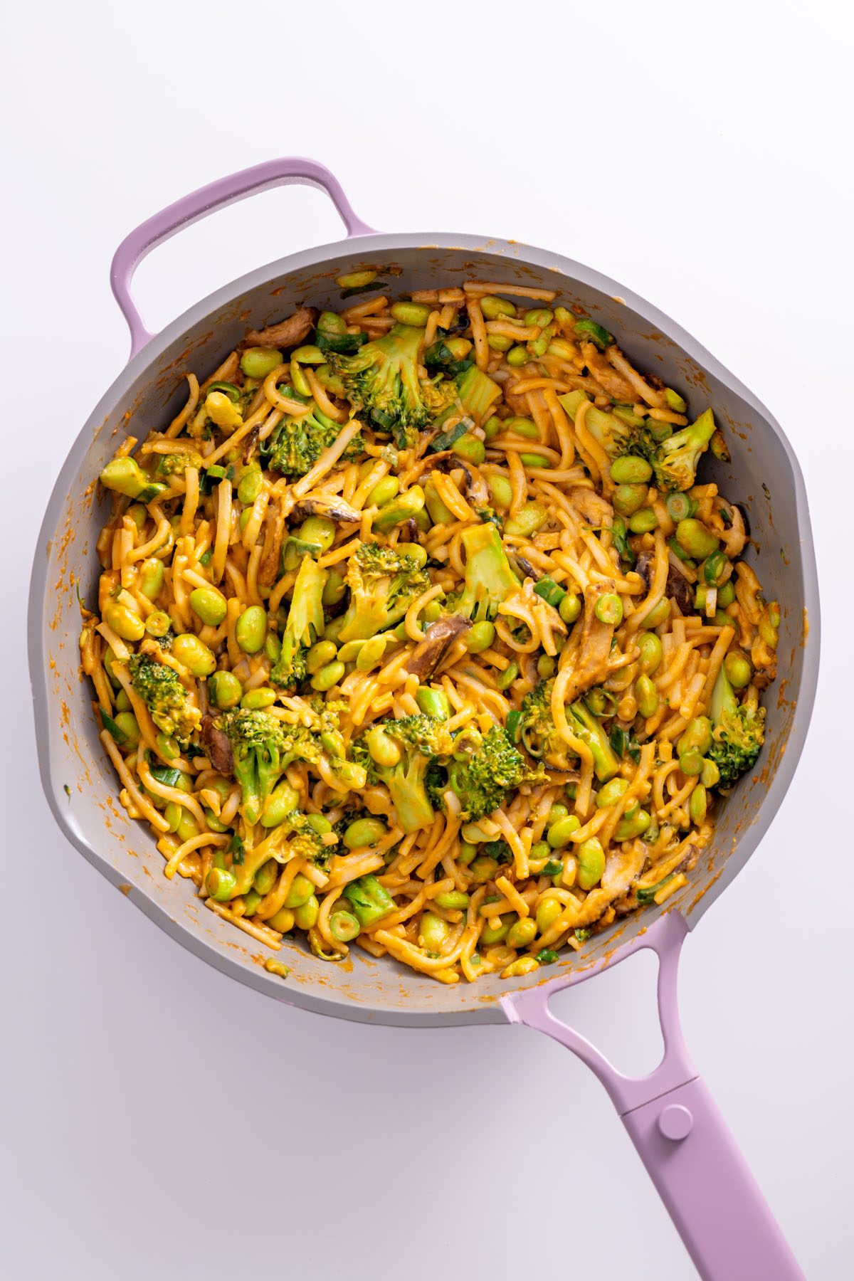 Overhead view of peanut gochujang noodles cooking in a pan.