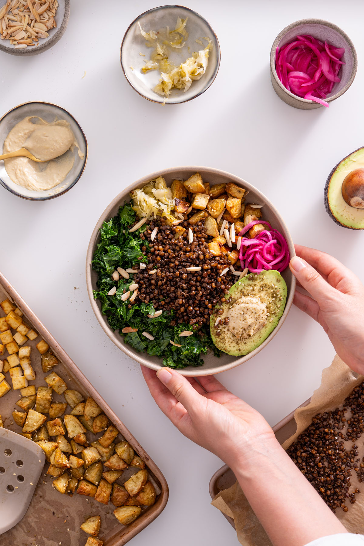Sarah Cobacho holding the completed crispy lentil and potato bowl.