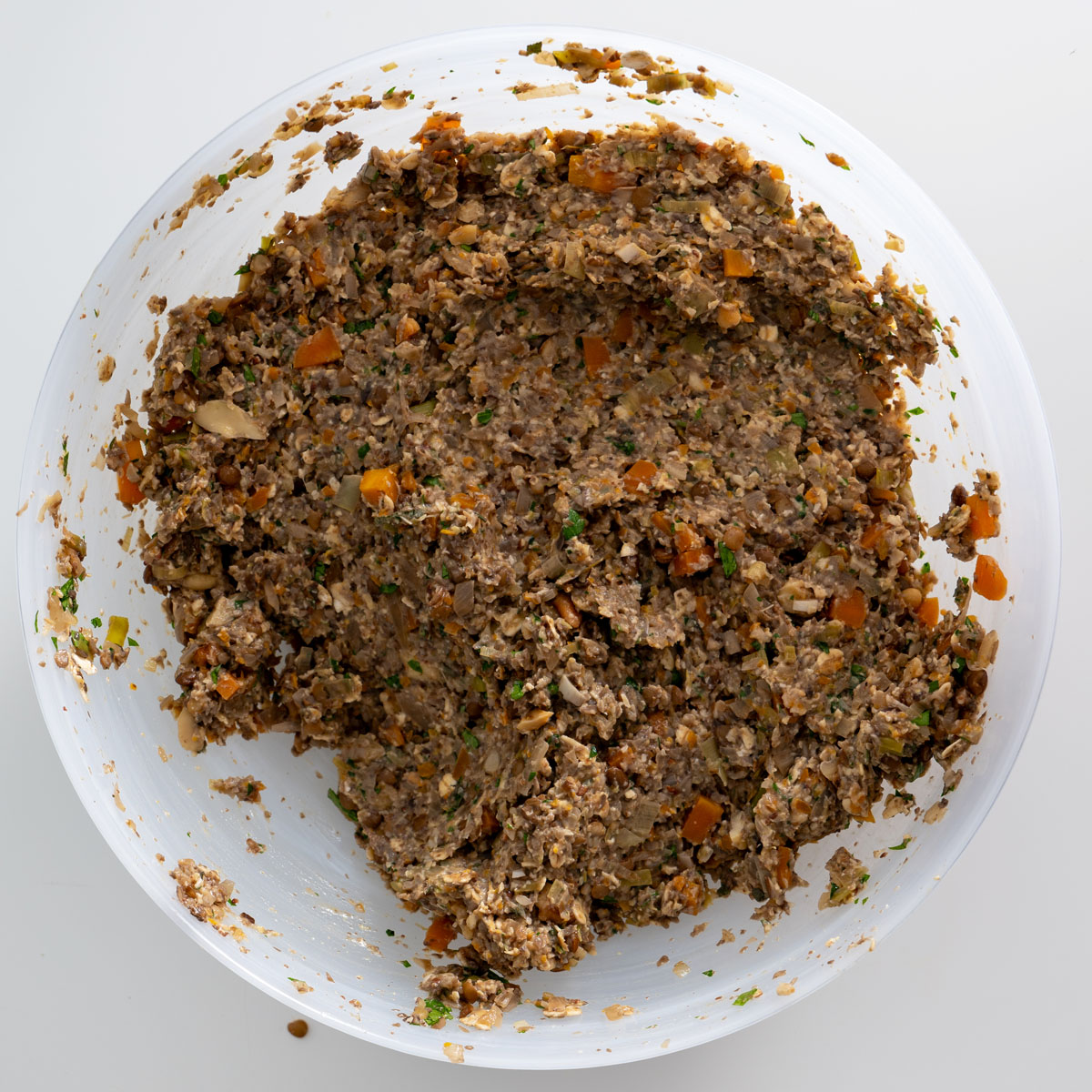 Process shot of the prepared mushroom Wellington filling mixture in a white bowl.