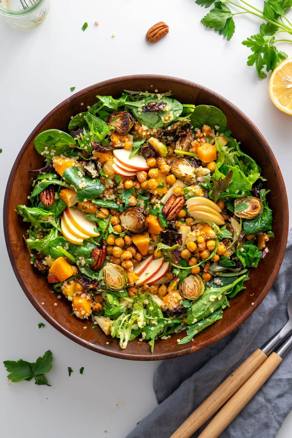 Close-up of a colorful fall salad with Brussels sprouts, roasted chickpeas, and fresh greens.