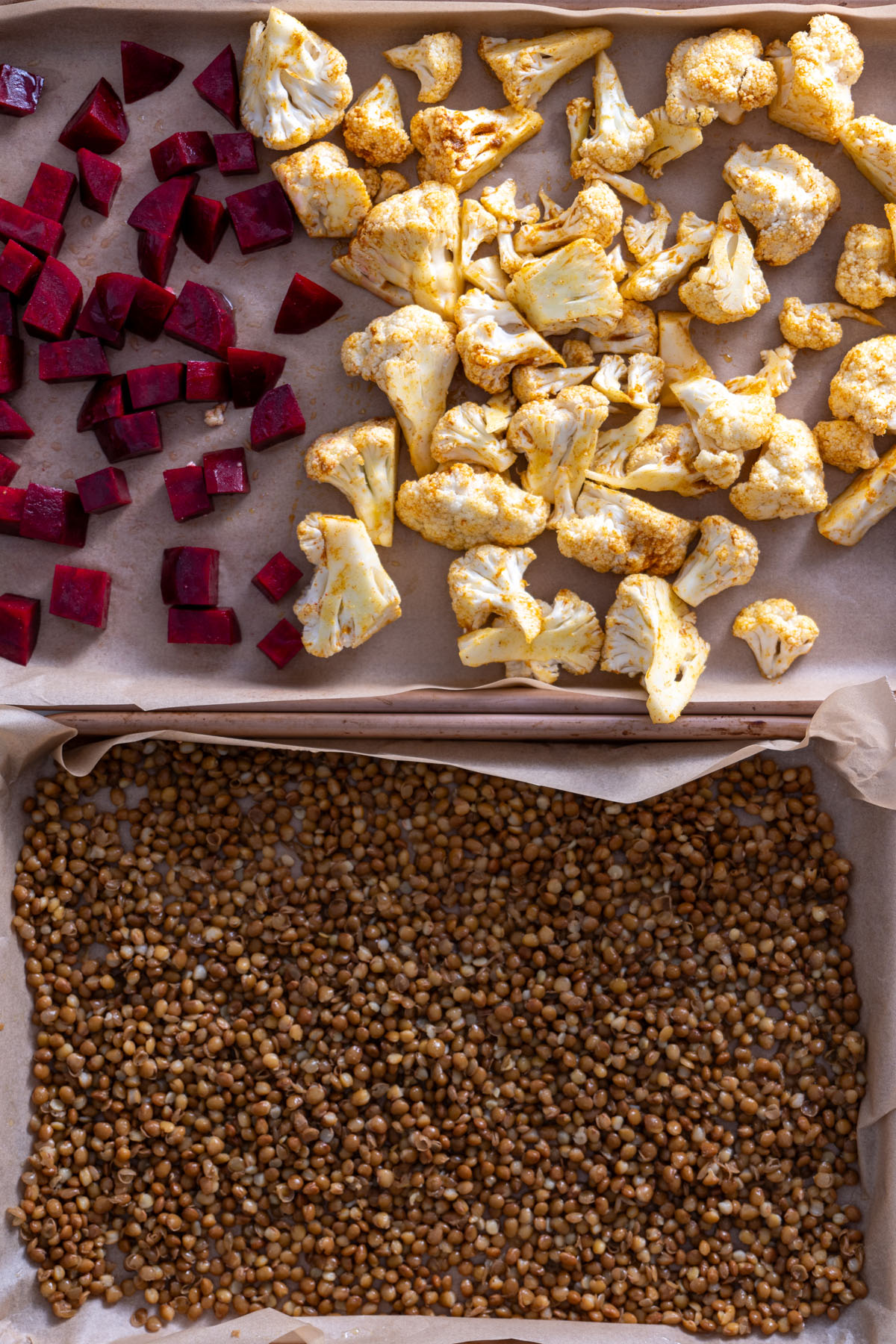 Ingredients for roasted cauliflower and crispy lentils laid out on parchment paper on a baking tray.