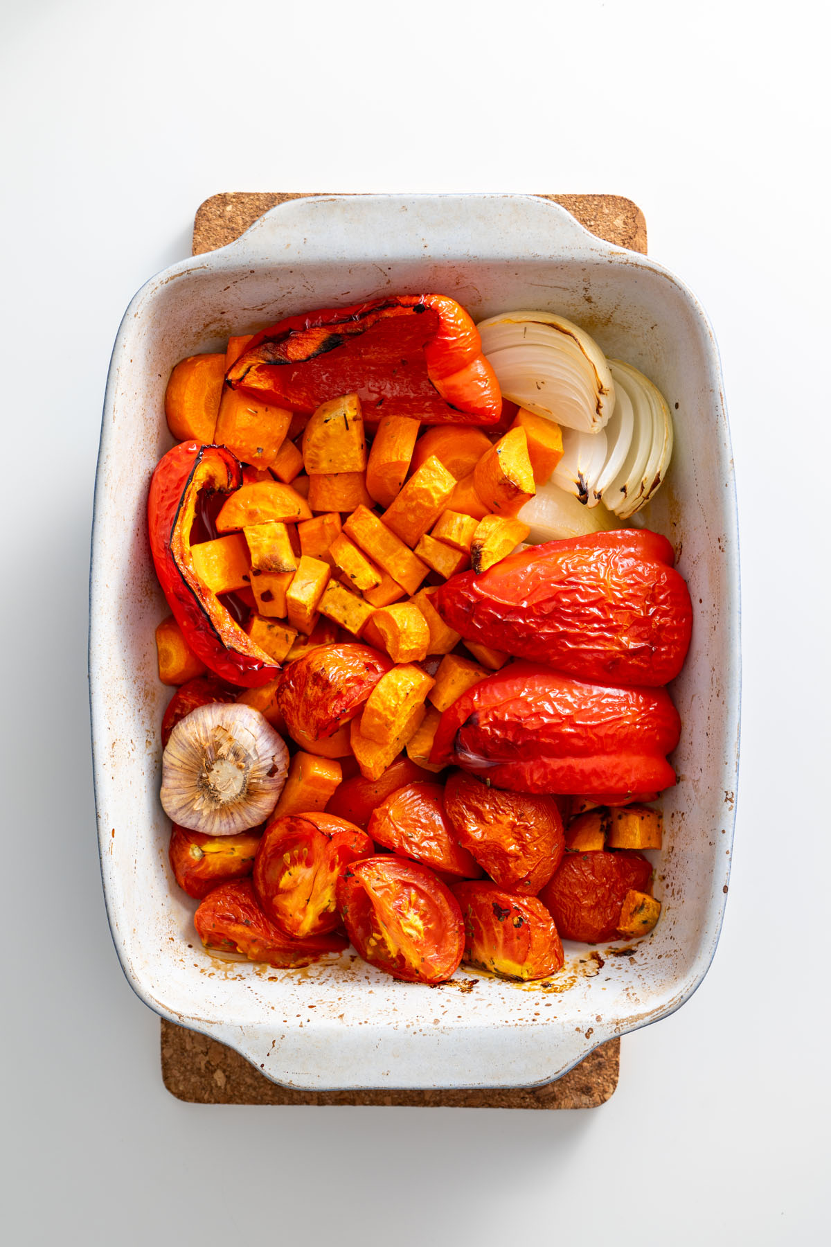 Roasted vegetables in a baking dish, caramelized to perfection.