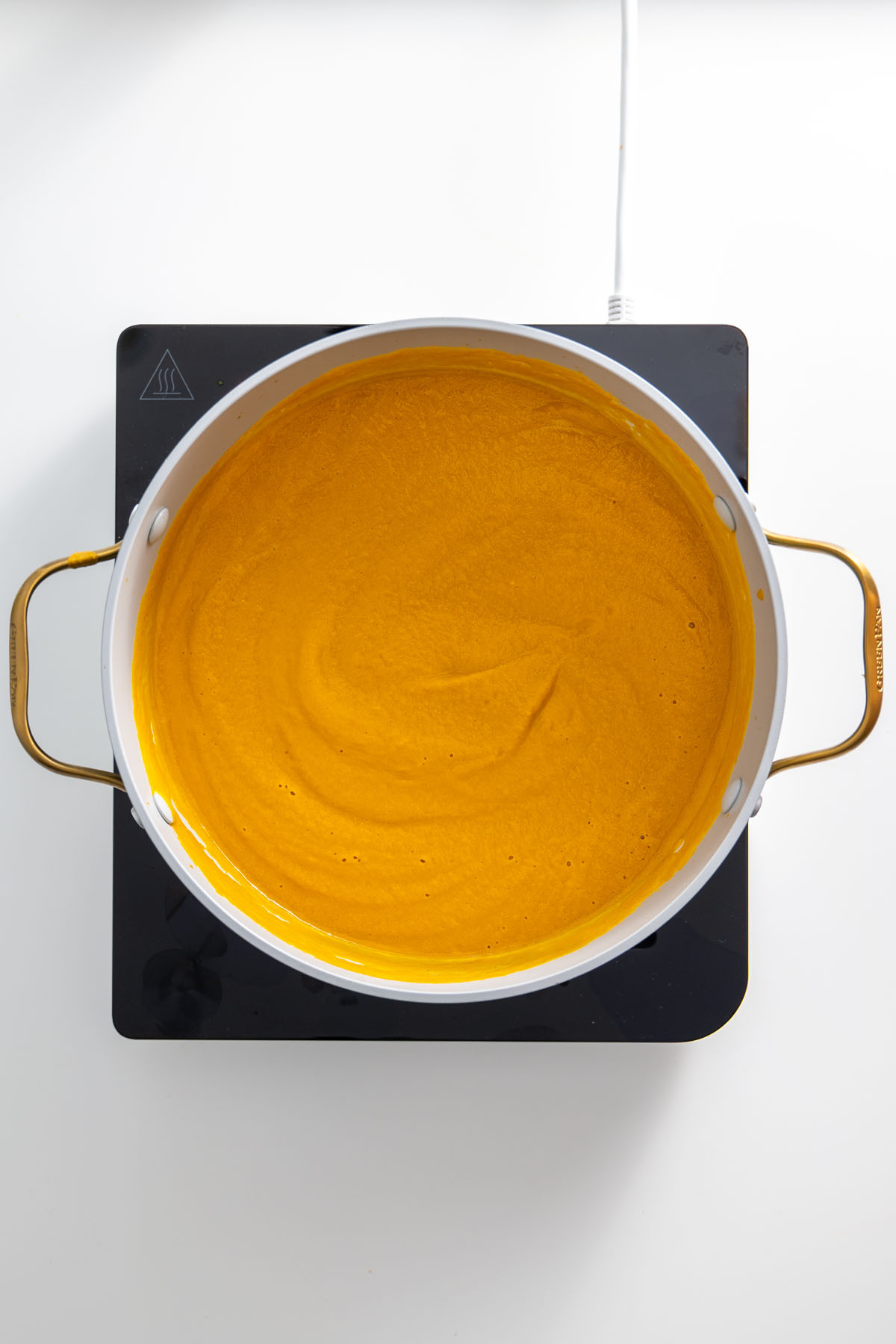 Smooth blended roasted vegetable soup in a large pot.