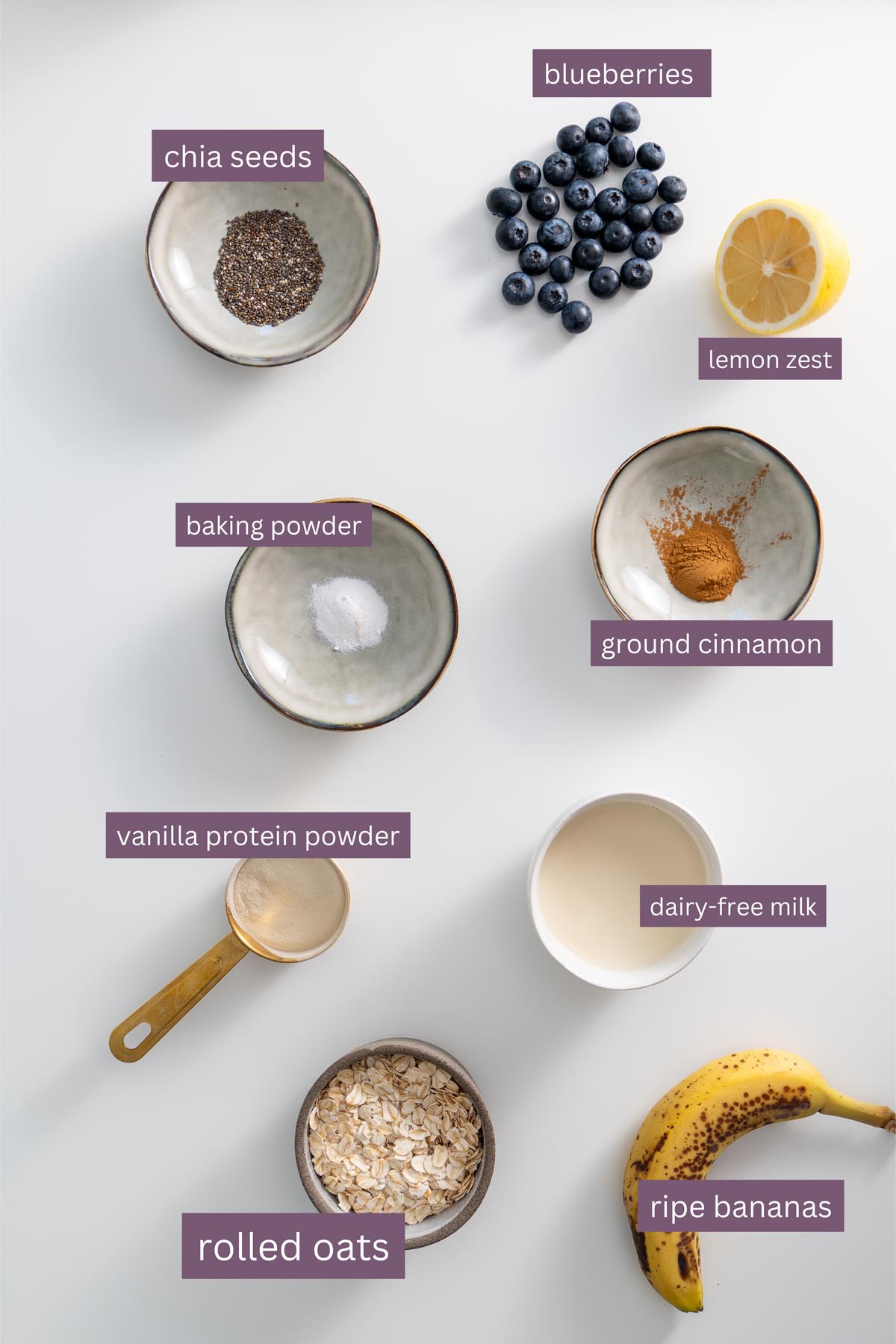 Ingredients for High-Protein Blueberry Baked Oats on a white surface