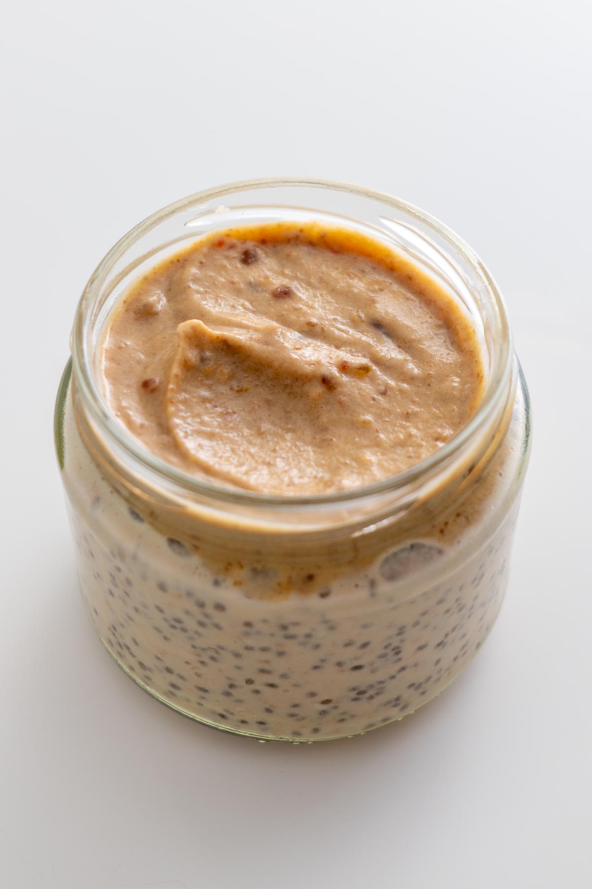 Close-up of peanut caramel spread on top of the overnight oats base.