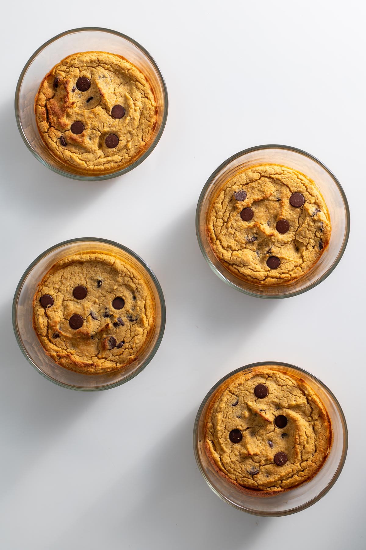 Multiple chickpea blondie bowls fresh from the oven on white background.