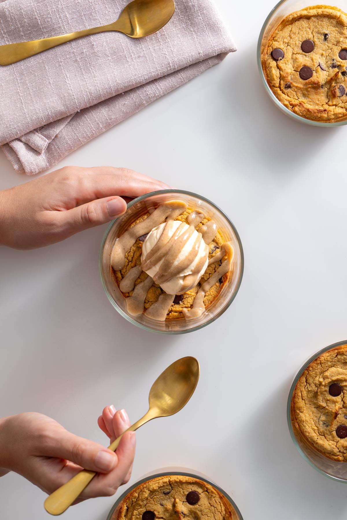 Unbaked chickpea blondie batter in small glass bowls topped with chocolate chips.