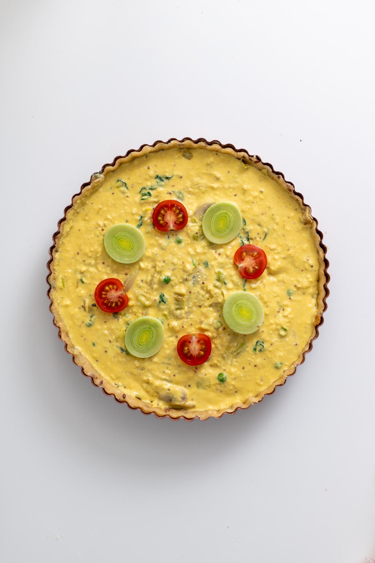 Leeks, mushrooms, peas, and spinach sautéing in a pan