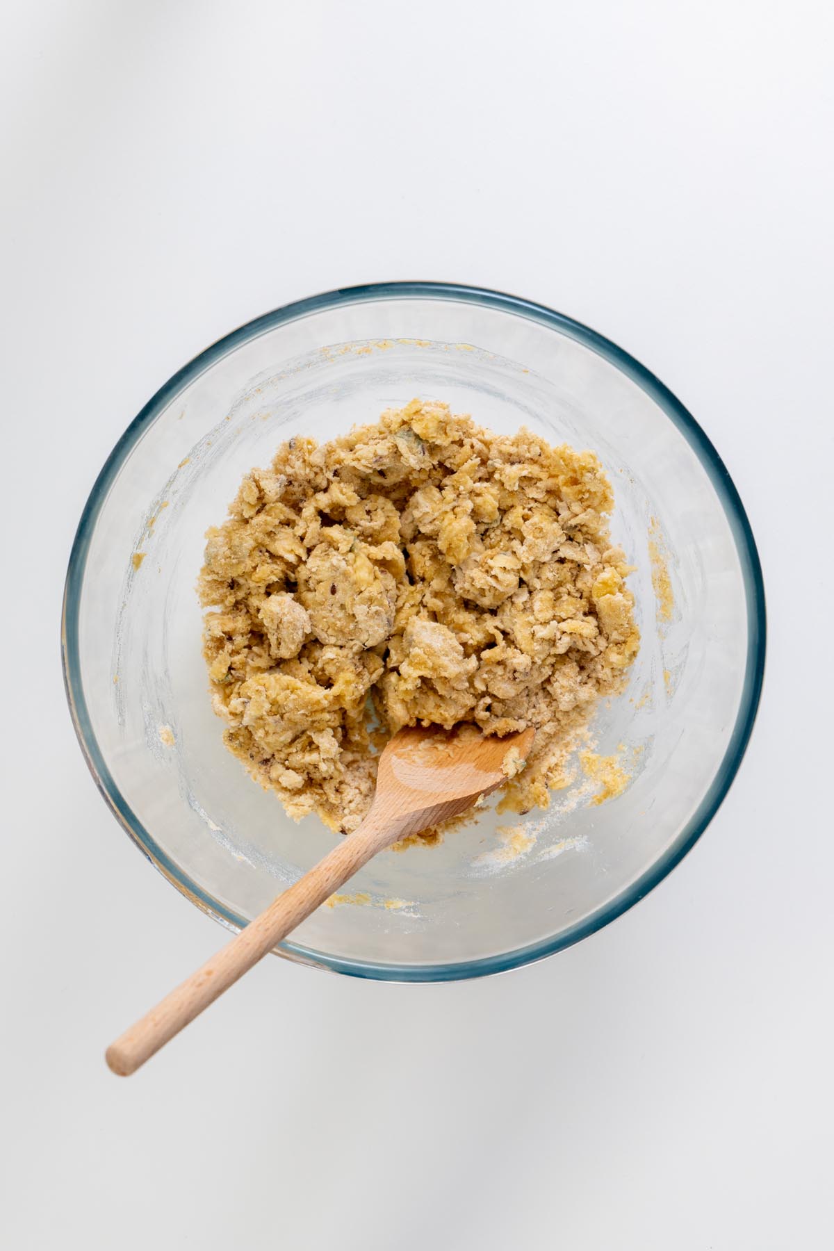 Flour mixture in a bowl with a wooden spoon