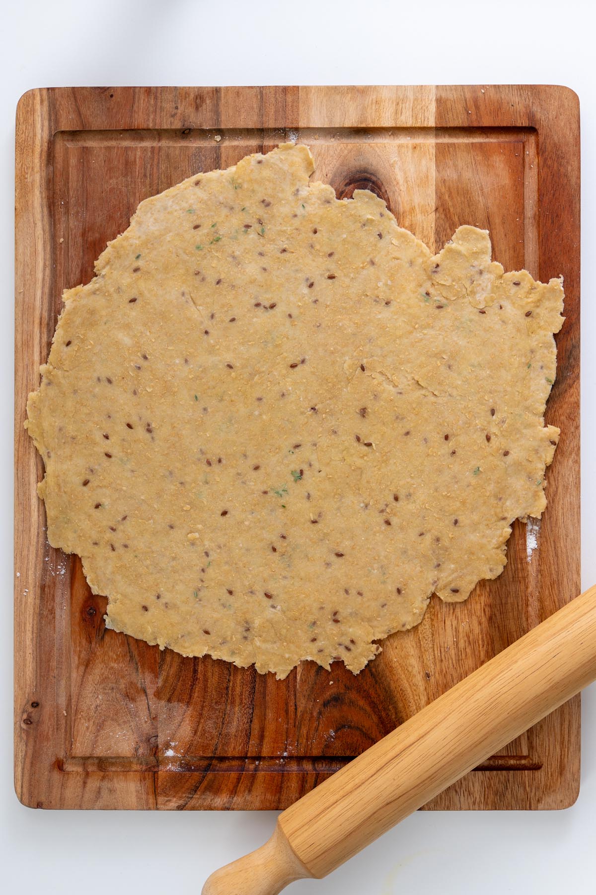 Raw pie crust pricked with a fork in a round tart tin