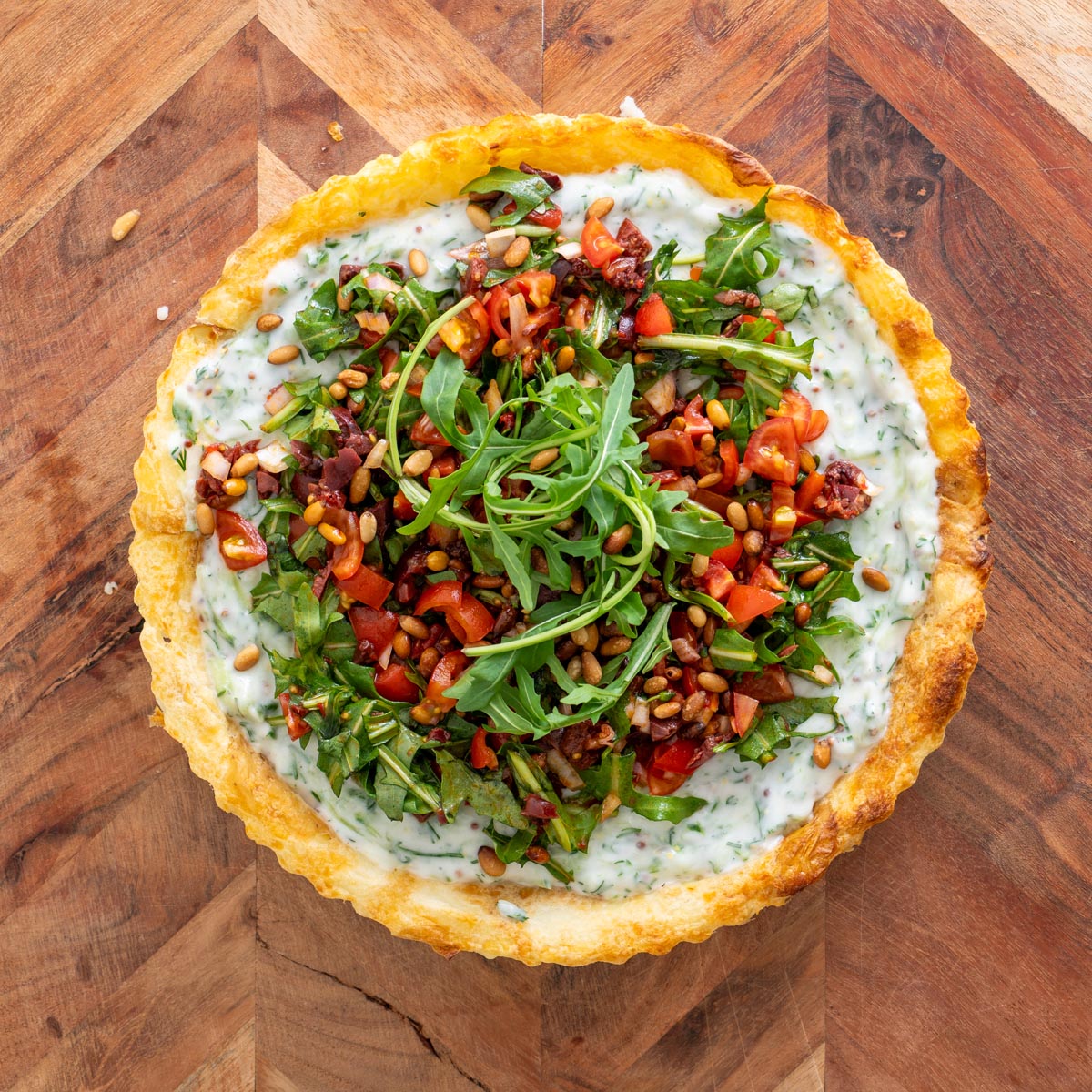 Tzatziki spread evenly over the baked potato crust