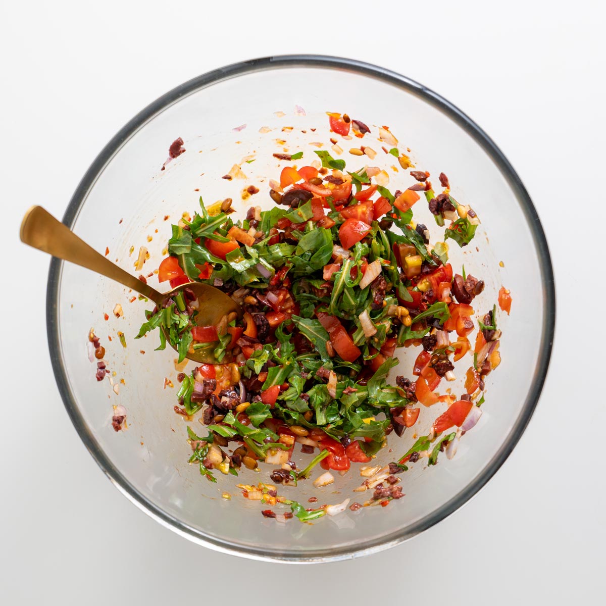 Olive mix combined with dressing, ready to top the tart